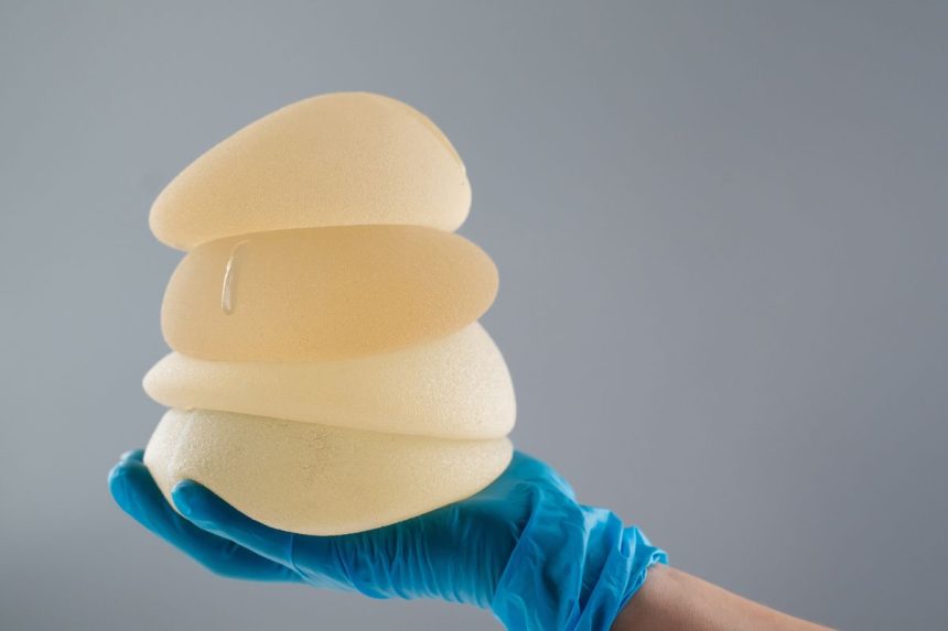 The surgeon held the different sizes of breast implants.